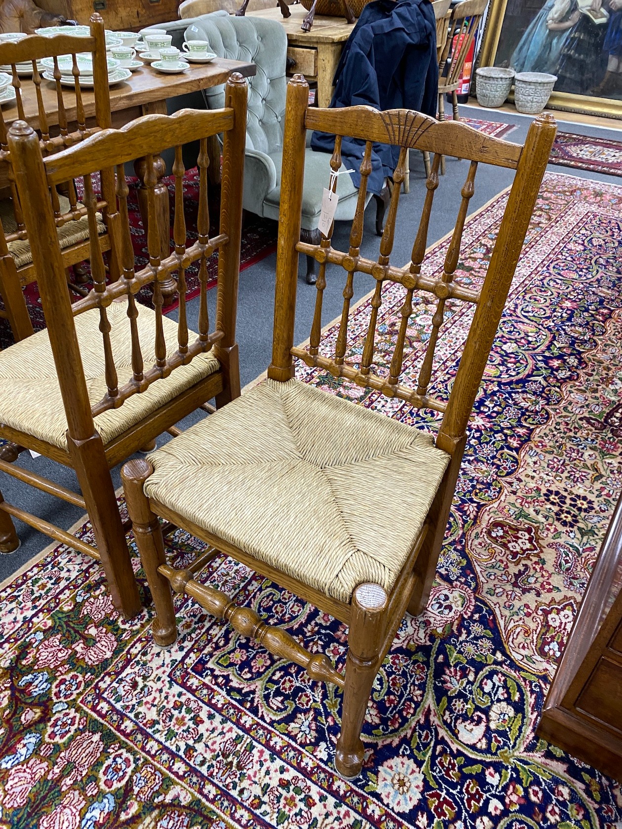 A set of eight Lancashire style oak spindle back rush seat dining chairs